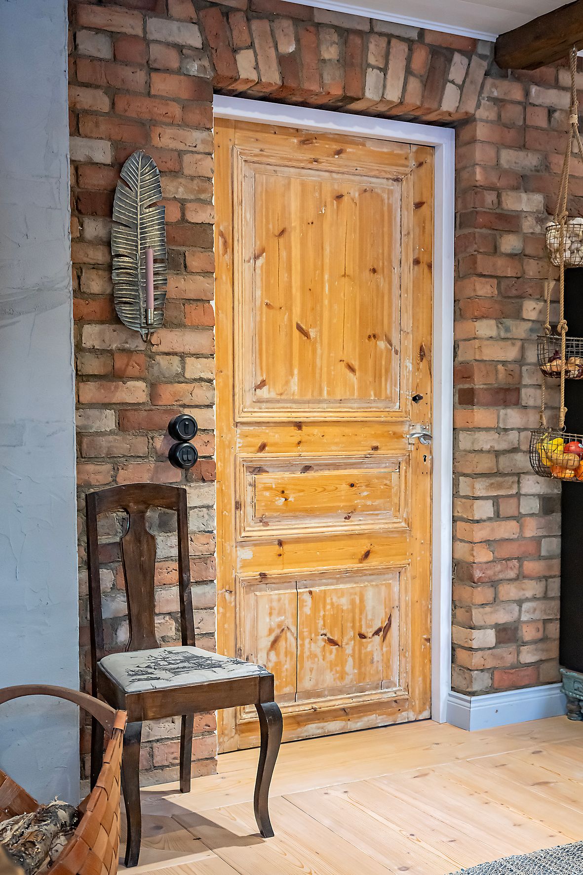 Tuvan tiilet ja ovi ovat kierrätystavaraa. Lattian kuusilankut on ruuvattu suoraan betonilaattaan, mutta ruuvit eivät näy päällepäin.